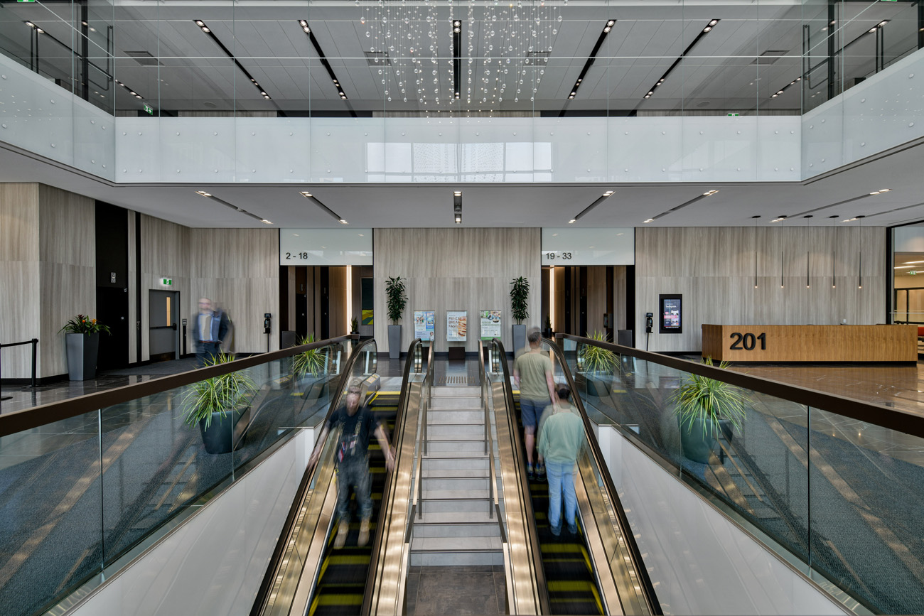 office lobby with people on escalator