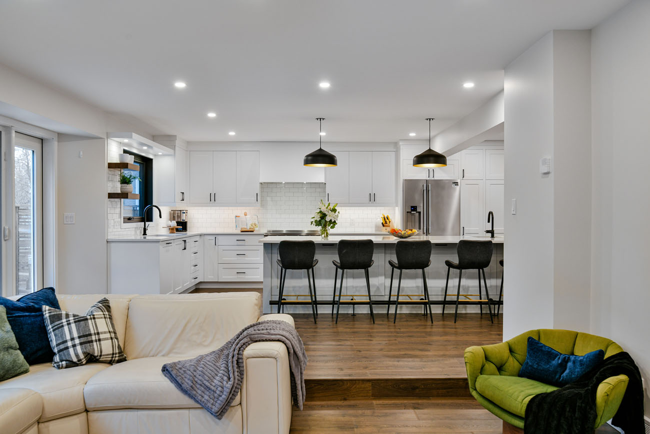 white kitchen and living area profile shot with wood floors